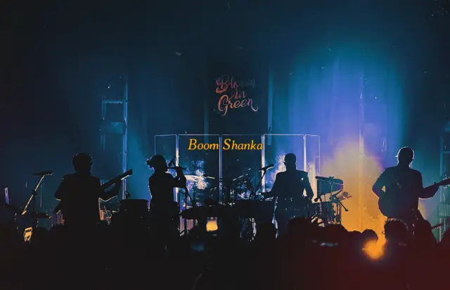 Boom Shanka. A band in silhouette on a blue-lit stage.